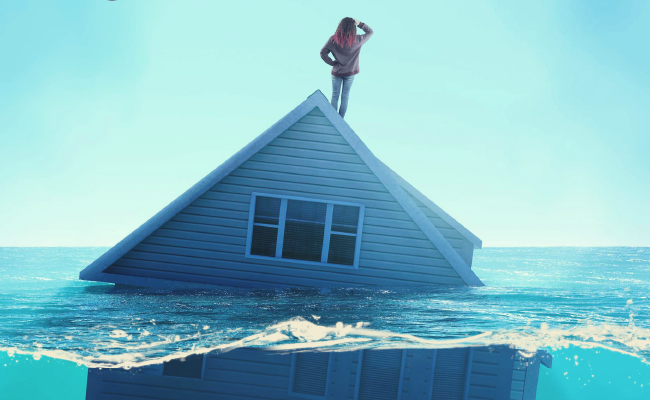 Woman standing on house that is floating in water